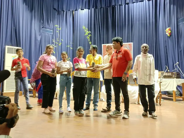 Adarsha Odisha plantation drive — young people receiving saplings on stage