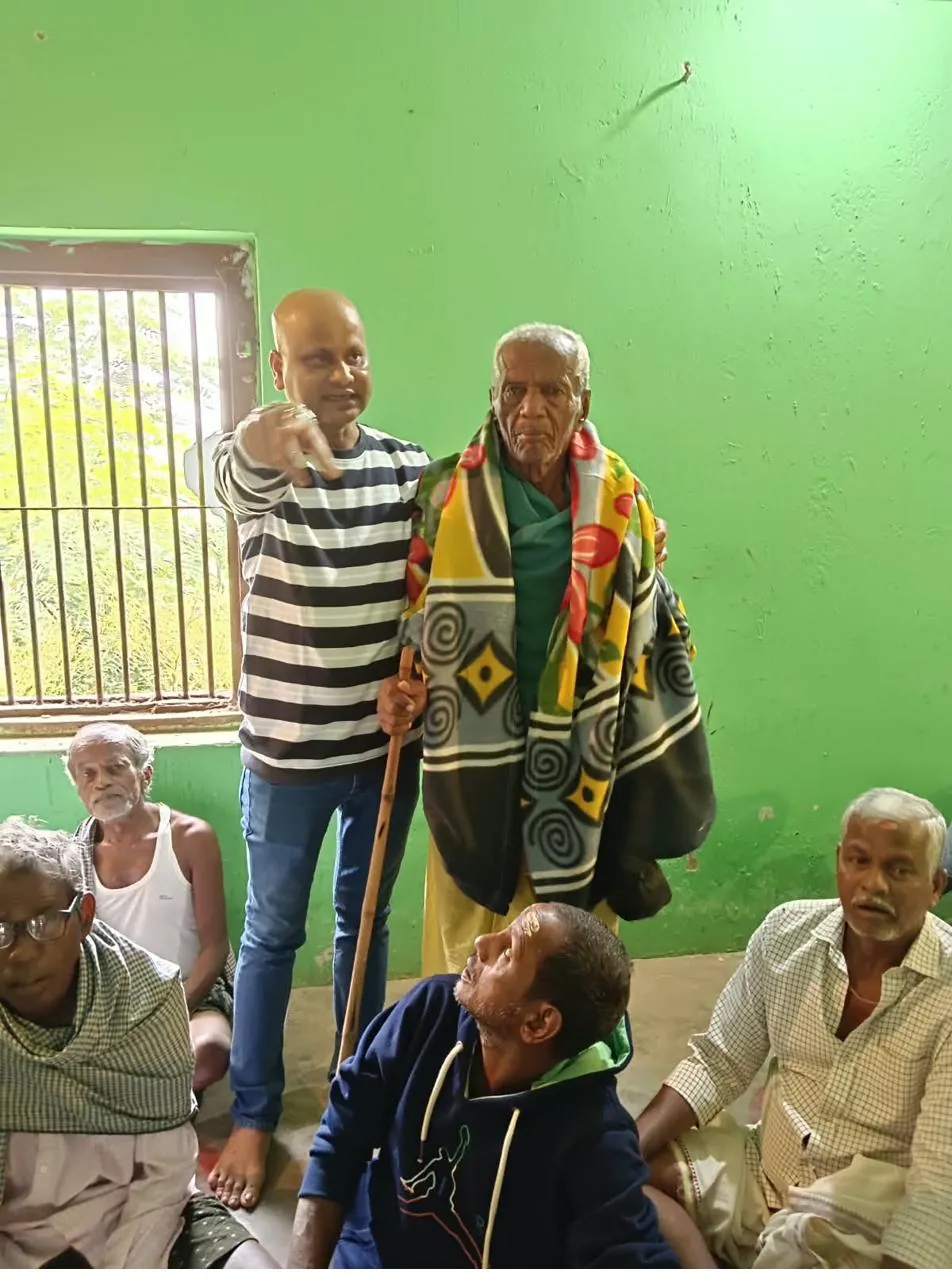 An Adarsha Odisha team member supporting a community member during an outreach and care visit